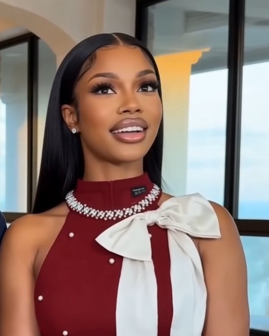 Oceaé in a burgundy dress with a white satin bow